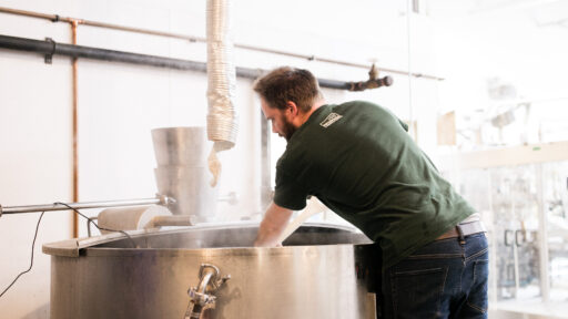 a man working in a large beer fermenter