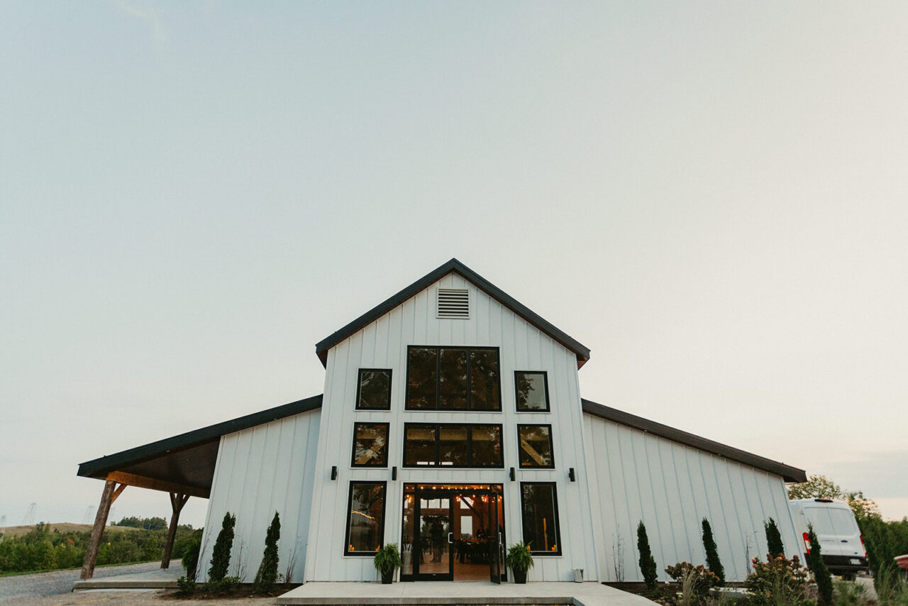 the exterior of a white, modern barn venue