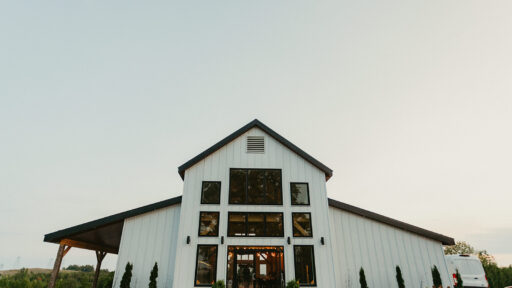 the outside of a white wedding venue