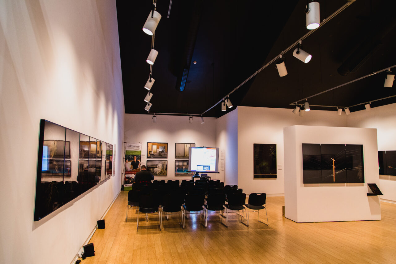 an image of an art gallery with empty chairs lined up
