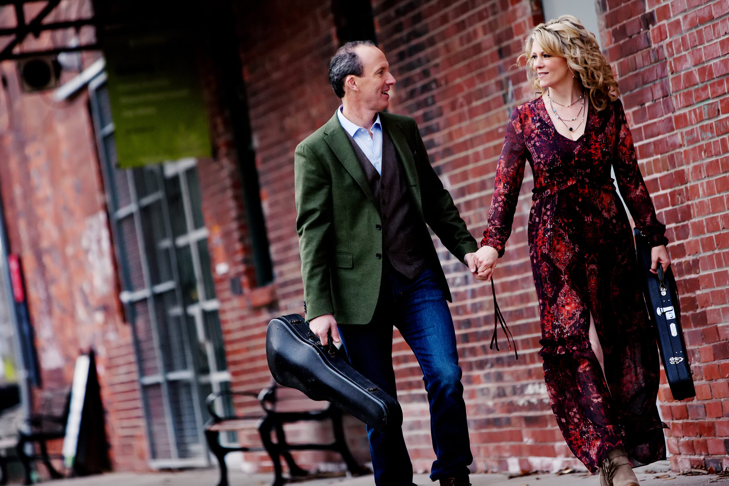Canadian artists Natalie MacMaster & Donnell Leahy walking together, carrying instruments