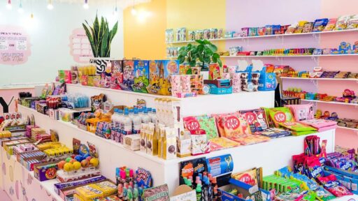 Brightly coloured room with shelves filled with a variety of candy