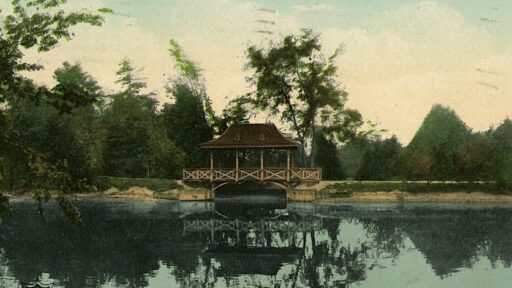 a historical image of a bridge in a park surrounded by water