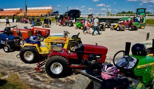 multiple tractors lined up for a show
