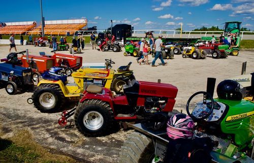 multiple tractors lined up for a show