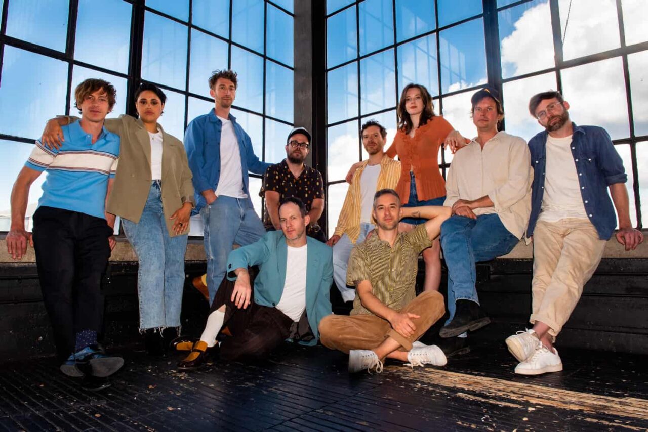 an image of 10 people in a band, posing for a camera