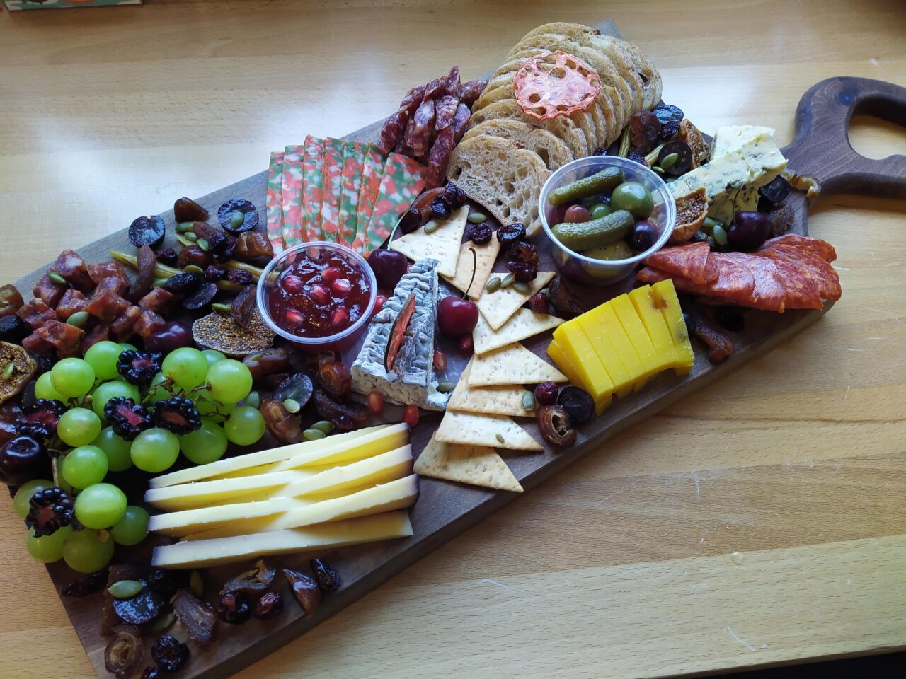 Charcuterie board with various meats and cheeses by The Cheesy Fromage
