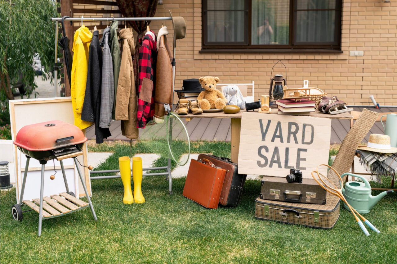 yard sale tables with various common yard sale items