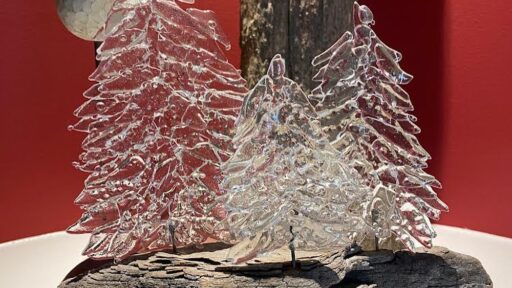 glass tree sculptures on wood