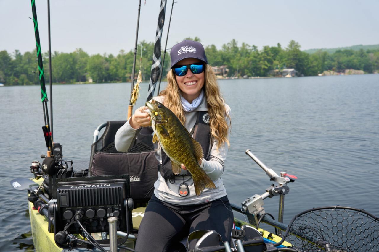 Author, Ashley Rae, with a smallmouth bass aboard her kayak. 