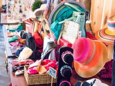 a table filled with different jewelry & crafts