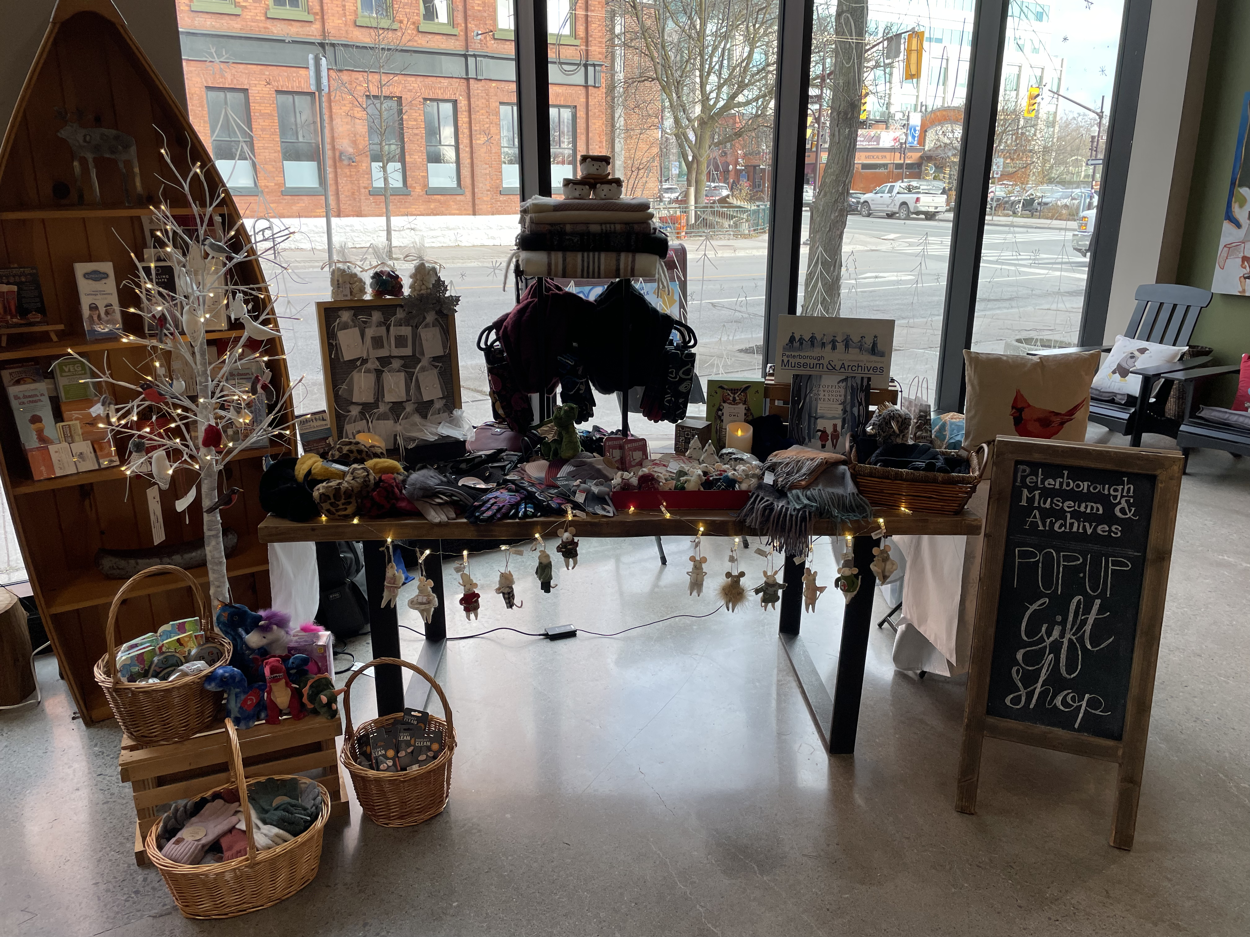 a table at a holiday market with different textiles for sale