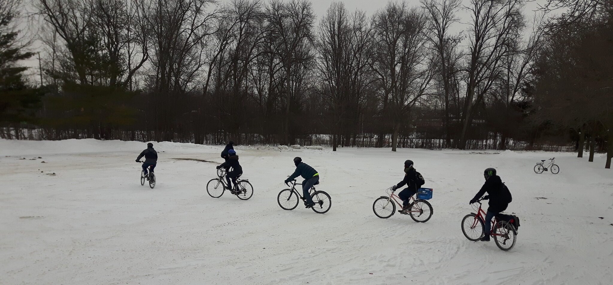 Five people cycling in snow