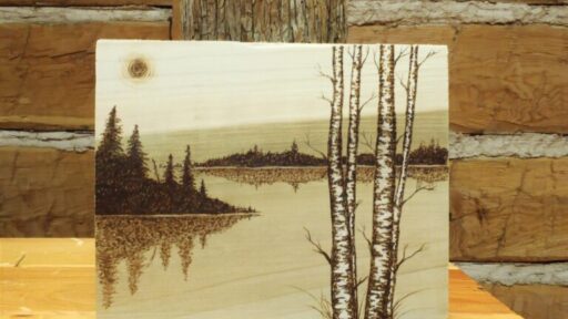 woodburning portrait of a lake landscape