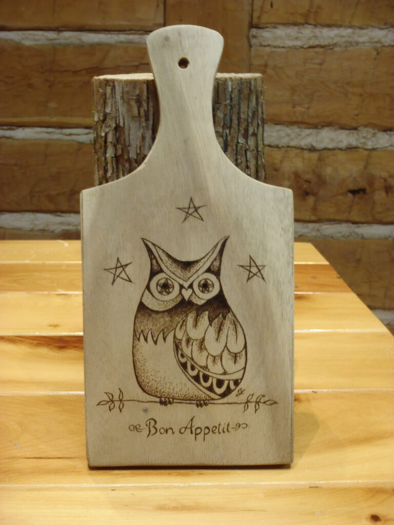 cutting board with an owl woodburnt into it