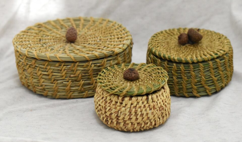 three pine needle baskets