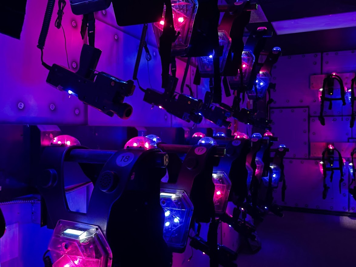 Laser tag gear hanging on the wall in a dark room