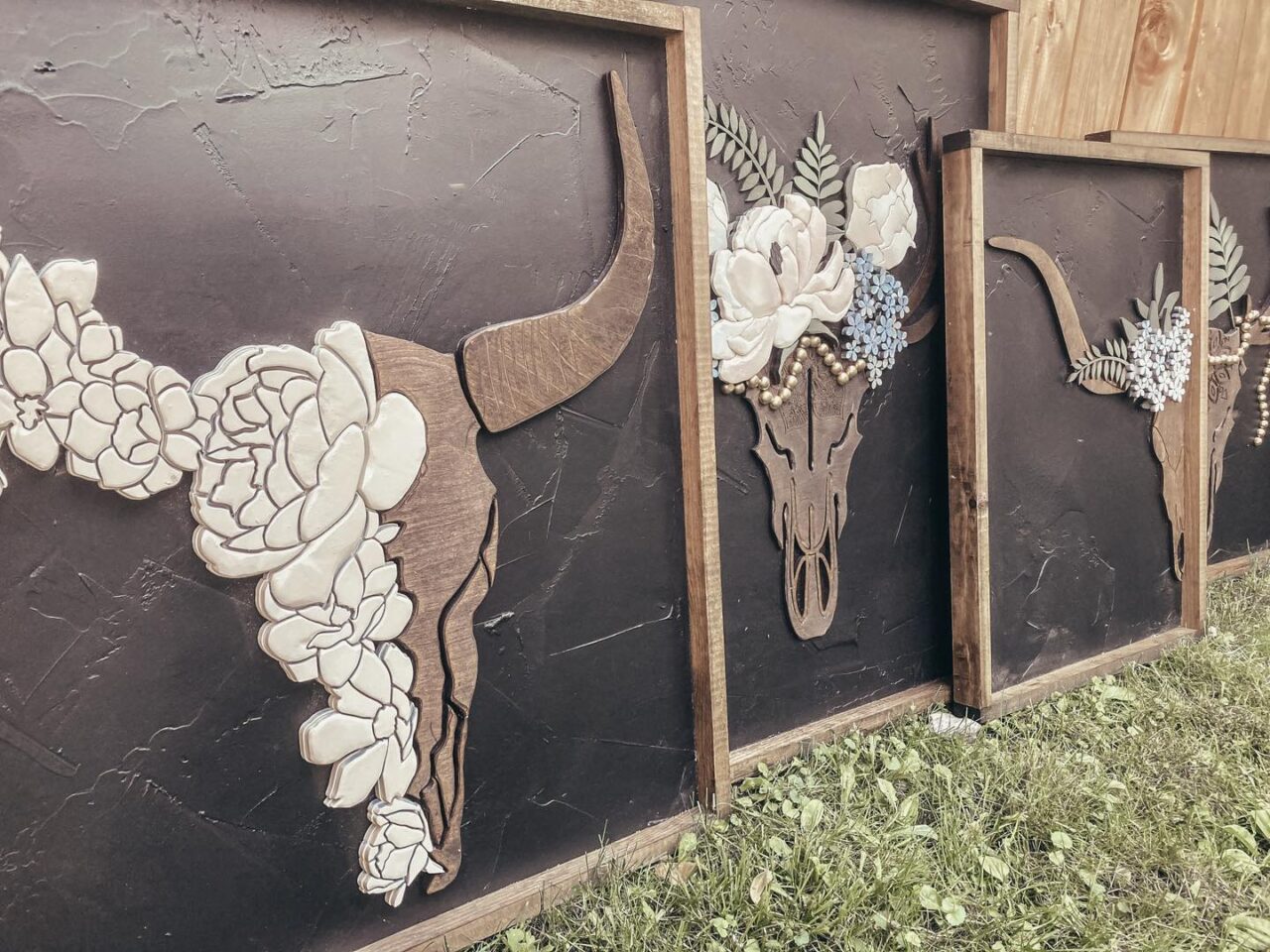 three canvases with bulls and flowers