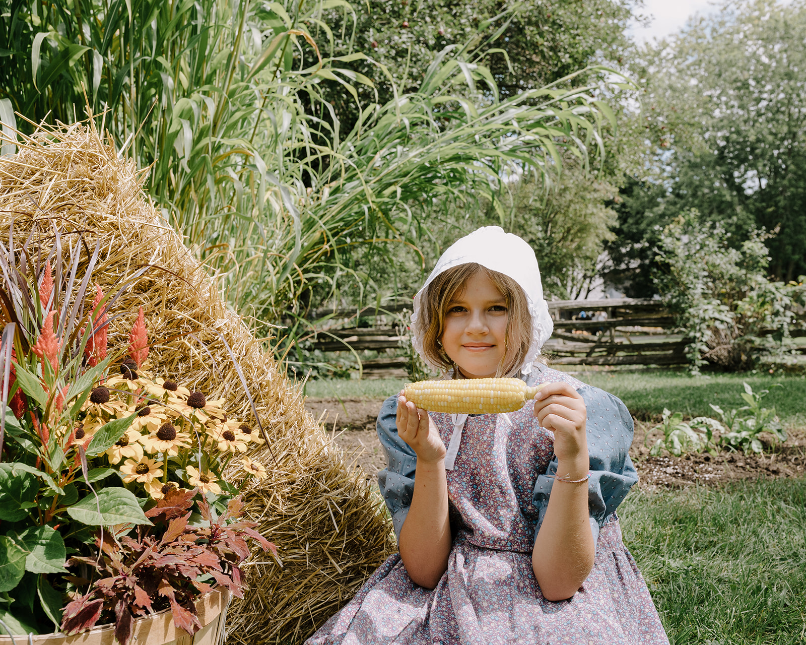 girl smiling holding corn