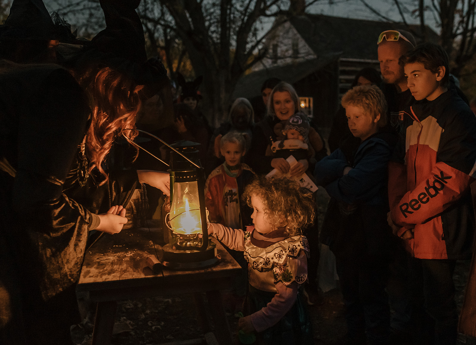 people standing in front of a lantern