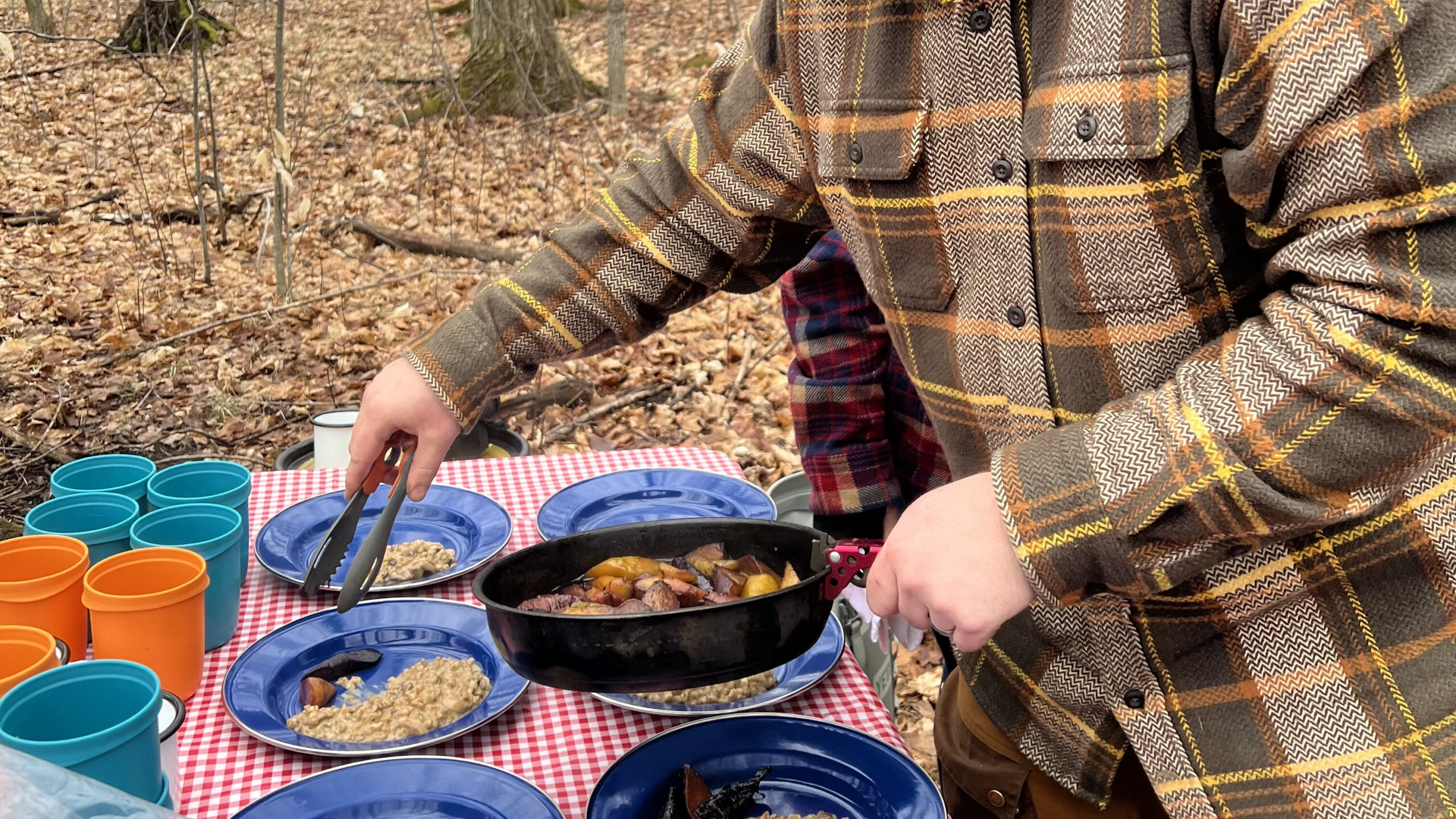 Chef Tyler Scott of serves up dishes at a unique maple infused menu at Red Mill Maple Syrup.

Photos shows hands serving food from a pan to plates.