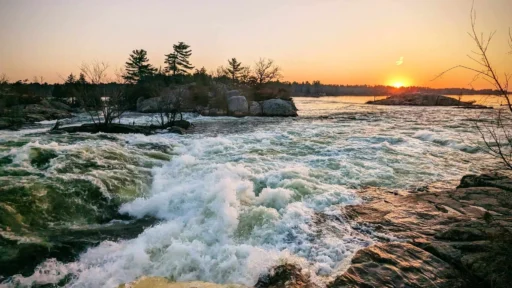 Rushing water with sun setting in the distance