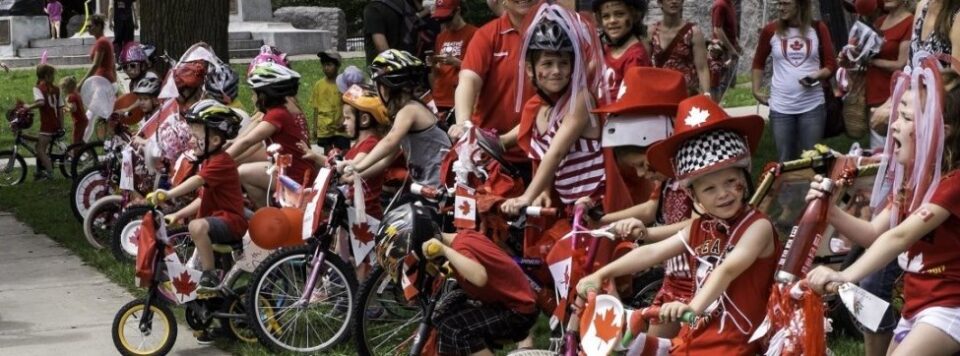 children on bikes wearing canada day outfits