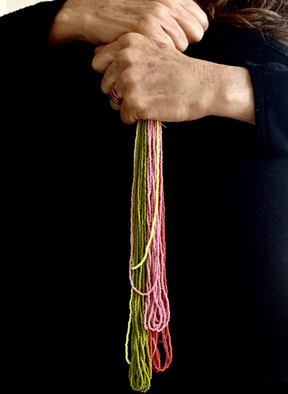 two hands holding beads