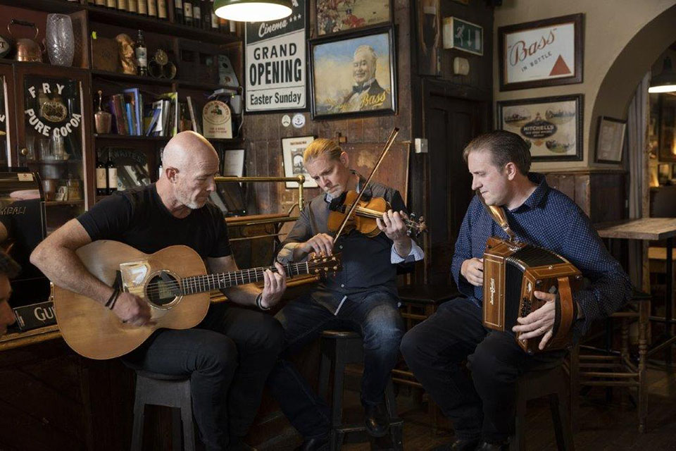 three men playing various intruments