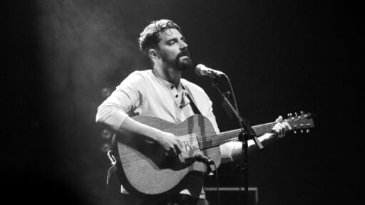 man singing with a guitar