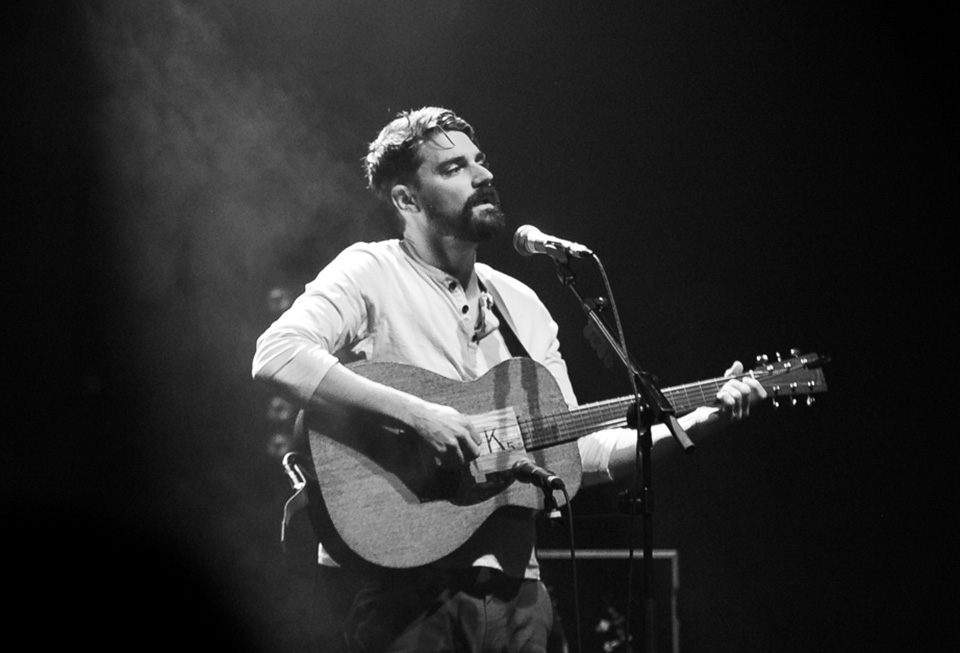 man singing with a guitar