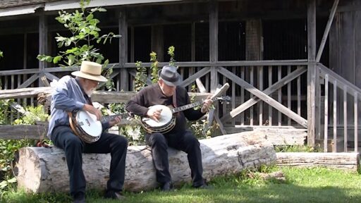 two men sitting playing instruments