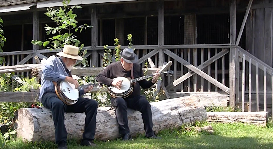 two men sitting playing instruments