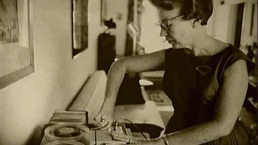 old photo of woman using a record player