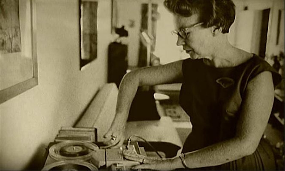 old photo of woman using a record player